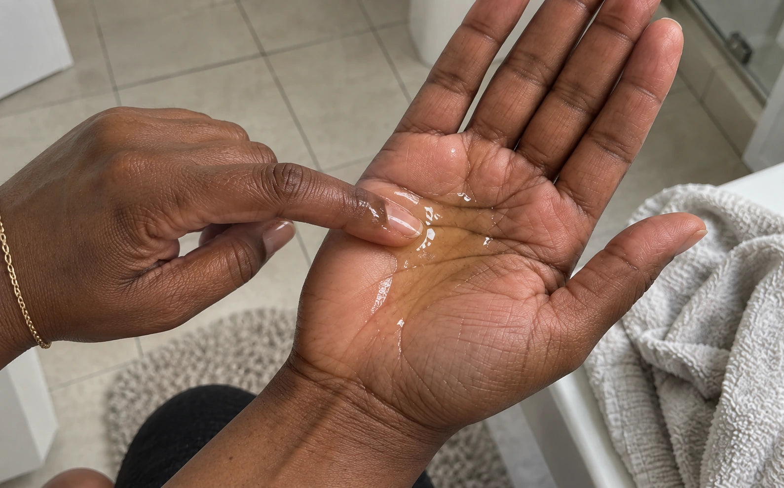 Texture illustration of a tiny oil drop being spread in a palm
